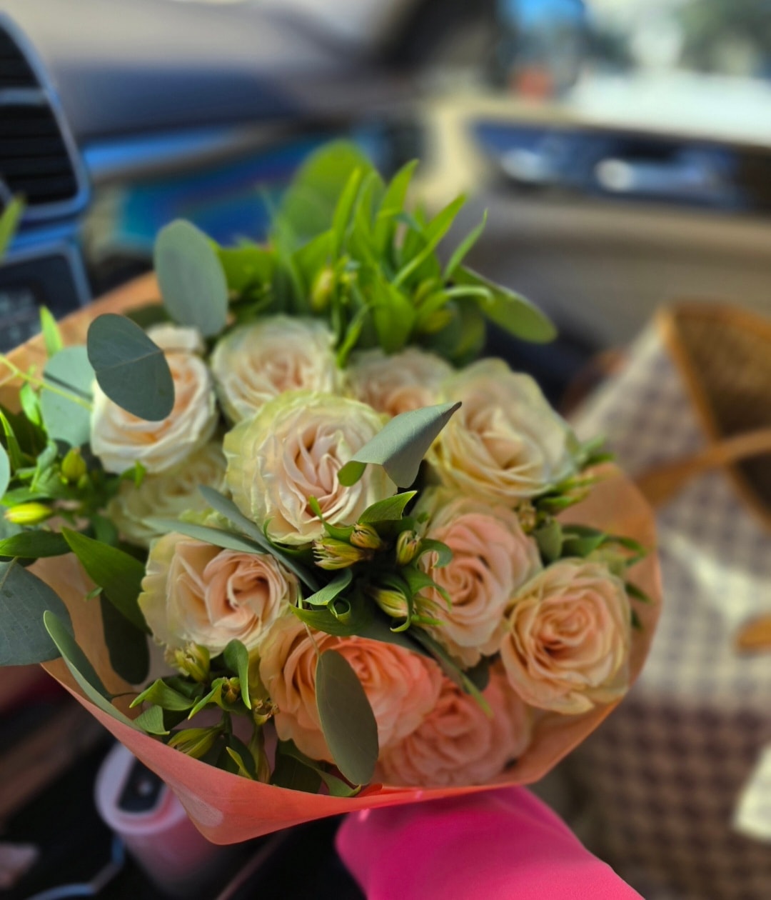 Florist tying ribbon on gift bouquet